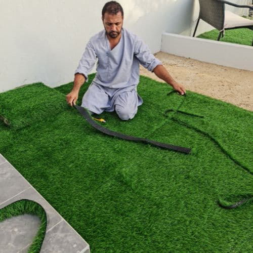 Artificial grass being laid on site — Al Quoz, Dubai